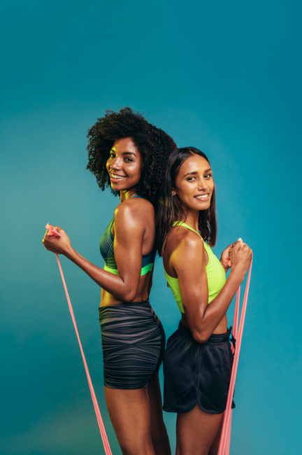 Two women holding resistance bands